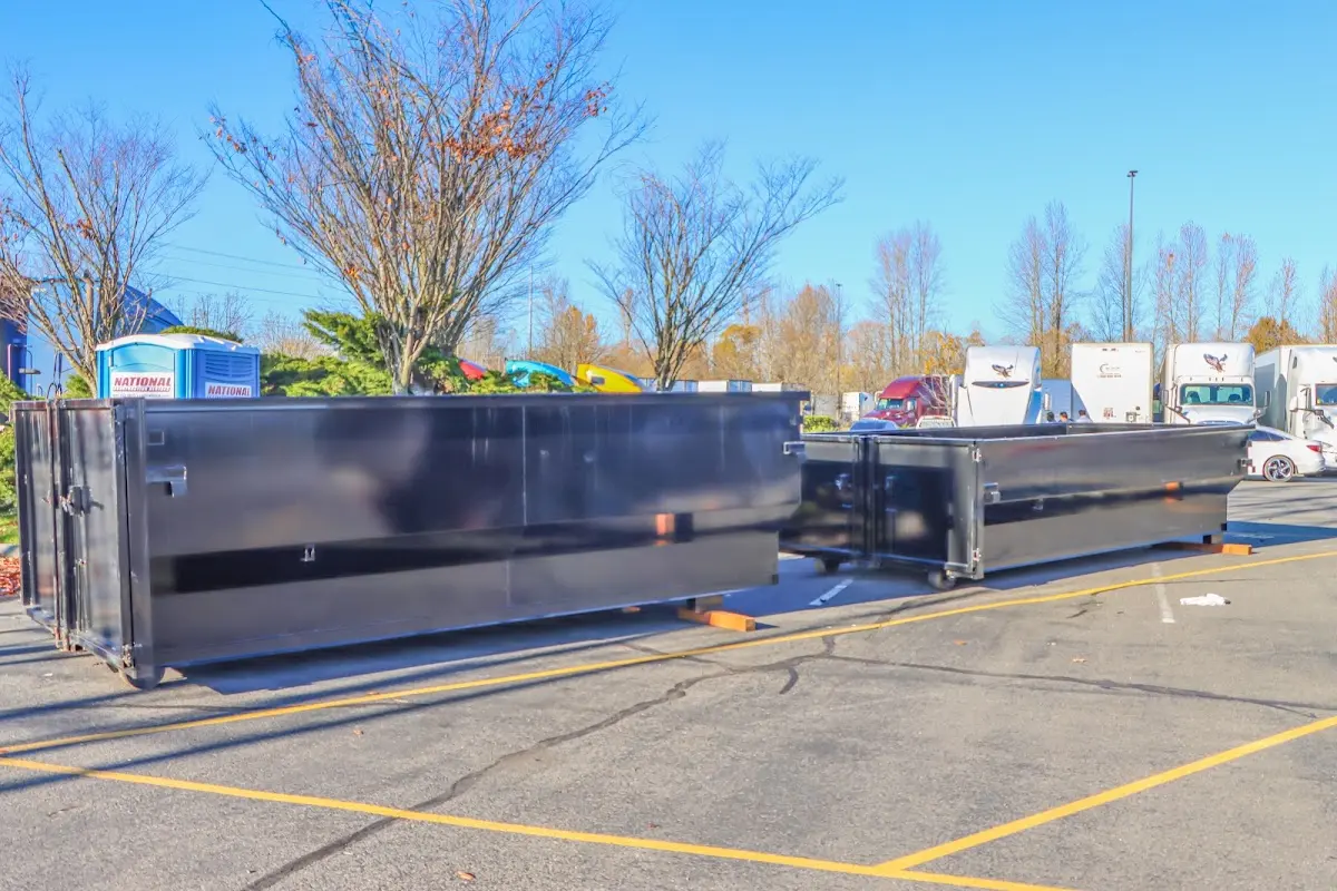 Professional dumpster rental service with roll-off container on residential driveway in Perry